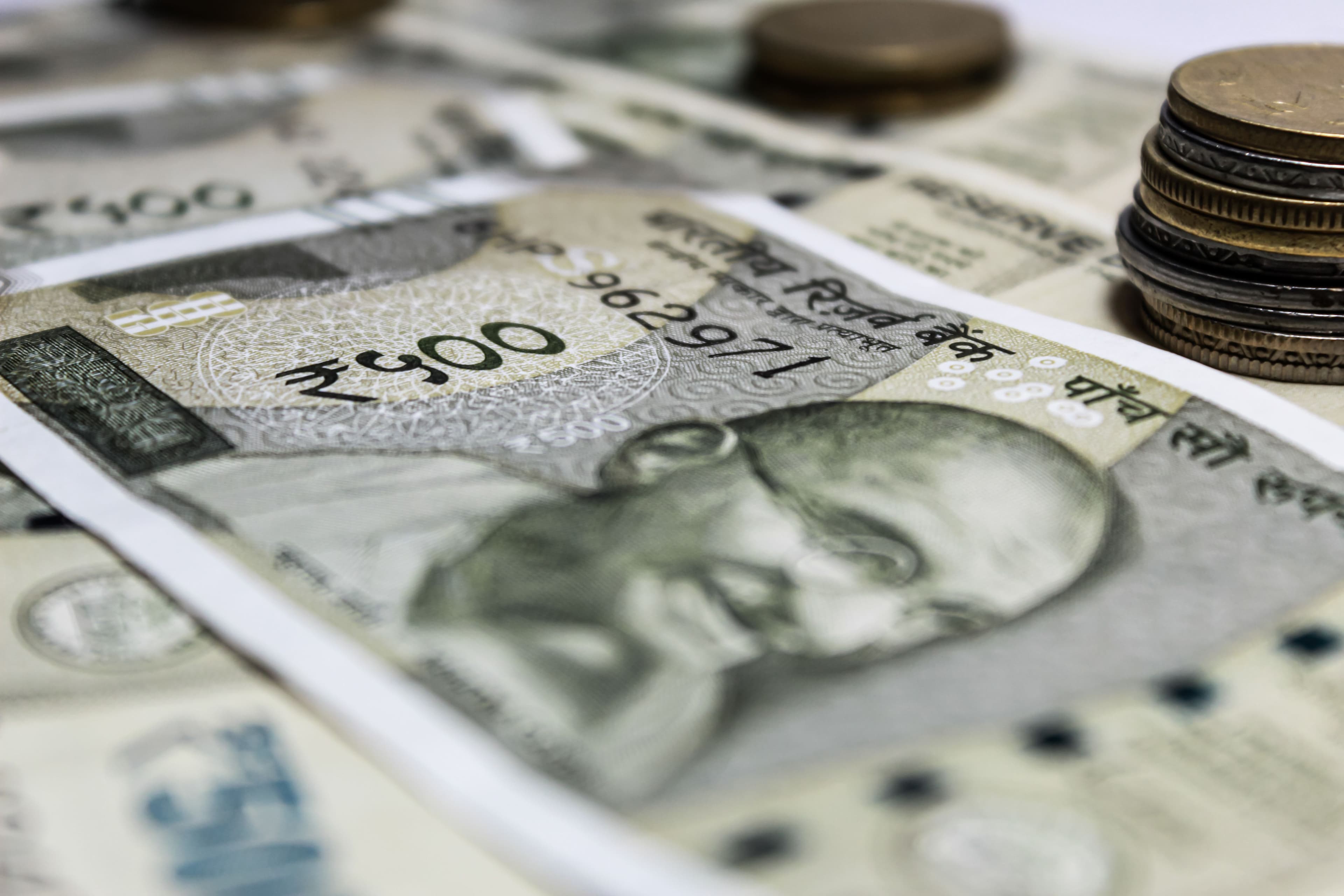 Indian currency notes and coins laid out together